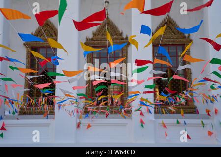 Colorful triangular festival flags hanging in a Buddhist temple courtyard, Bangkok, Thailand, 31 January, 2025 Stock Photo