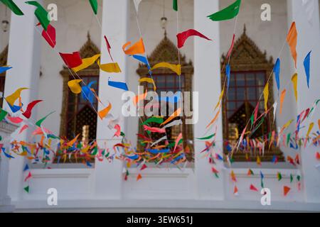 Colorful triangular festival flags hanging in a Buddhist temple courtyard, Bangkok, Thailand, 31 January, 2025 Stock Photo
