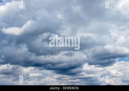 Dramatic Overcast Sky with Heavy Grey Clouds and Blue Patches Stock Photo
