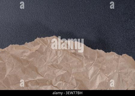 Brown Torn Kraft Paper Border on Black Background Stock Photo
