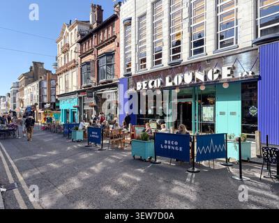 Outdoor cafe seating on Bold Street with independent restaurant storefronts. Liverpool, England, United Kingdom. Stock Photo