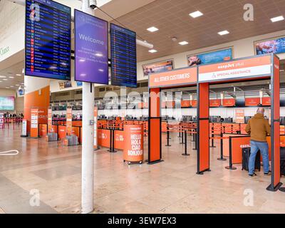 A passenger at the easyJet bag drop check-in desks at Liverpool John Lennon Airport in the United Kingdom. Stock Photo