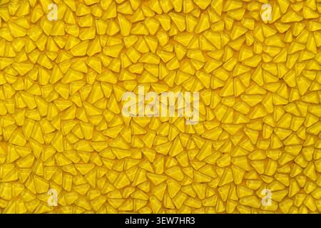 Yellow mosaic pattern background with small triangular glass tiles. Stock Photo