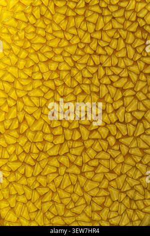 Yellow mosaic pattern background with small triangular glass tiles. Stock Photo