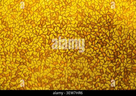 Yellow mosaic pattern background with small triangular glass tiles. Stock Photo