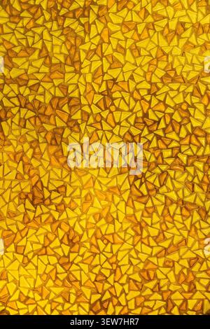 Yellow mosaic pattern background with small triangular glass tiles. Stock Photo