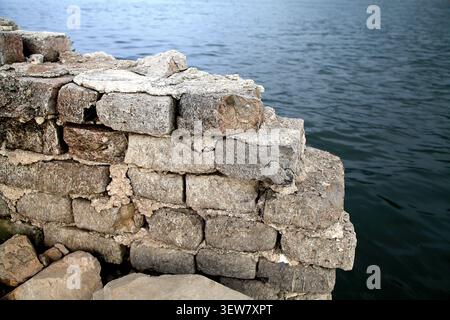 This is a close-up of a section of the "Underwater Great Wall" at Panjiakou Reservoir, constructed from interlocking light gray granite blocks. The st Stock Photo