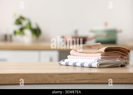 Stack of kitchen towels on wooden countertop Stock Photo