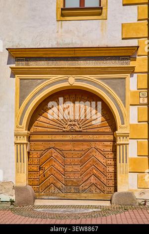 Ornate wooden front entrance doorway to old apartment building that is on the SNP central square in city of Banska Bystrica, Slovakia, Central Europe Stock Photo