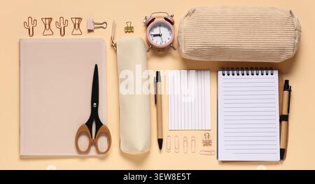 Flat lay of beige stationery and office supplies on peach background Stock Photo