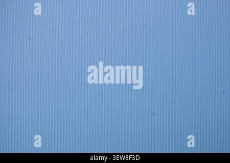 Detailed full frame background of a light blue corrugated plastic or polycarbonate surface with small dust particles. This clean minimalist material b Stock Photo