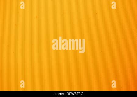 Detailed full frame background of a bright orange corrugated plastic or polycarbonate surface. This clean minimalist material backdrop with fine verti Stock Photo