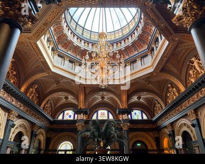 Low angle view of the ornate Great Room ceiling, dome, and crystal chandelier at The Merchant Hotel, Belfast, Northern Ireland. Stock Photo