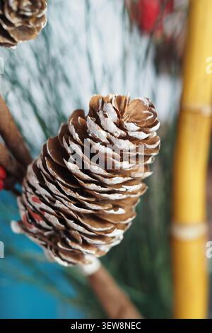Pine cone sits on a wooden surface in a simple display Stock Photo