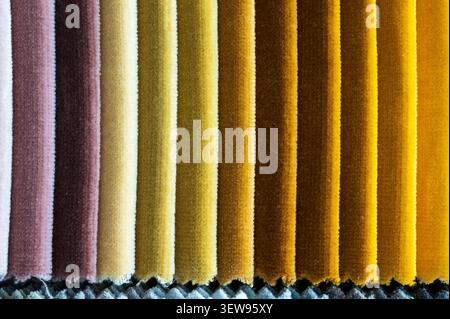 Close up texture of colorful velvet fabric swatch catalog samples arranged in vertical stripes Stock Photo