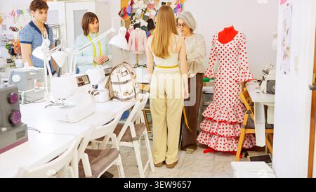 Fashion students learning dressmaking skills in a workshop Stock Photo