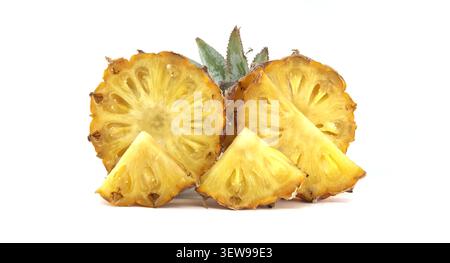 A close-up view of bright yellow pineapple slices and wedges, showcasing their juicy texture and tropical appeal against a plain white backdrop Stock Photo