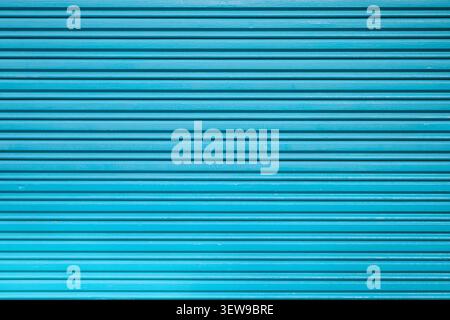 Front view background of a corrugated metal door with a roller shutter texture. Security concept for warehouse and garage entrances. Stock Photo