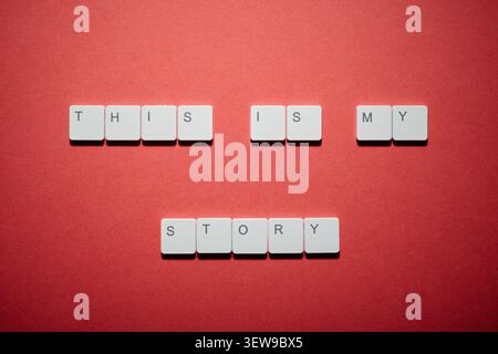 This is my stroy text written witk white keys of a keyboard on a red table. Nostalgia for story personal concept. Stock Photo