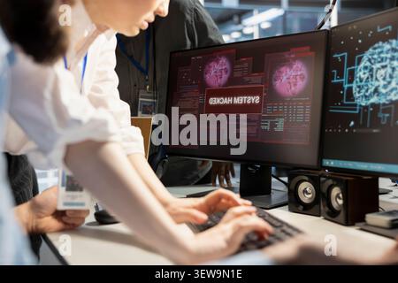 Engineering team reviews cyber threat alerts in a data center while working to protect infrastructure from security breaches. Stock Photo