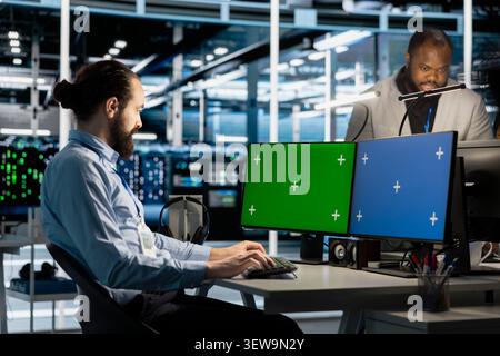 IT specialist uses a chroma key computer in a data center for diagnostics, server monitoring and screen replacement. Stock Photo