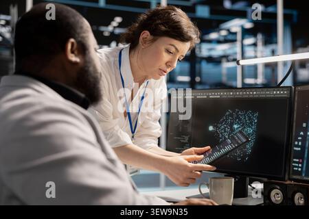 Data center team works together on diagnostics, maintenance tasks and server equipment performance checks. Stock Photo
