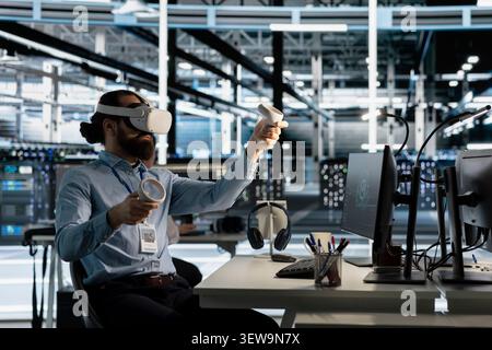 Data center engineer uses a VR headset to configure server virtualization and AI automation systems in a data center. Stock Photo
