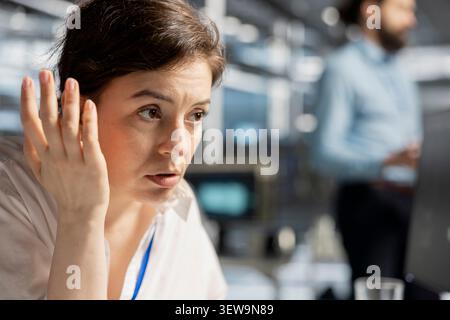 System administrator inspects server infrastructure, performs maintenance checks and reviews equipment diagnostics. Stock Photo