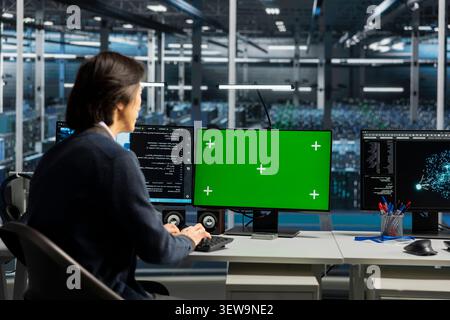 IT specialist uses a chroma key computer in a data center for diagnostics, server monitoring and screen replacement. Stock Photo
