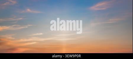 Colorful Sunset Sky With Soft Clouds and Dramatic Sun Rays Background Stock Photo