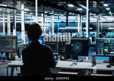 Data center engineer works on a computer to monitor AI systems, neural networks and server infrastructure. Stock Photo