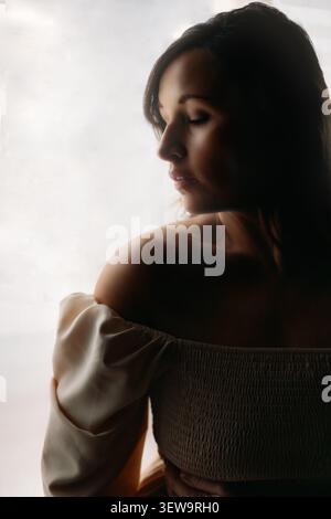 Serene woman with closed eyes in soft light Stock Photo