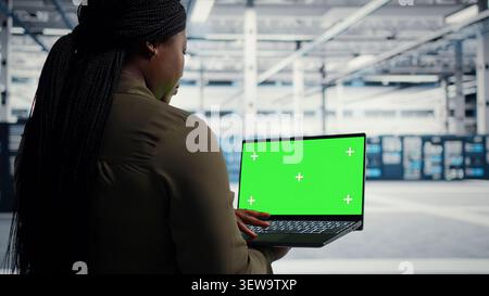 IT colleagues collaborate in a data center while reviewing AI diagnostics and infrastructure performance. Stock Photo