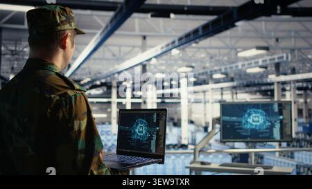 Military IT specialist reviews reconnaissance information with AI software in a server room environment. Stock Photo