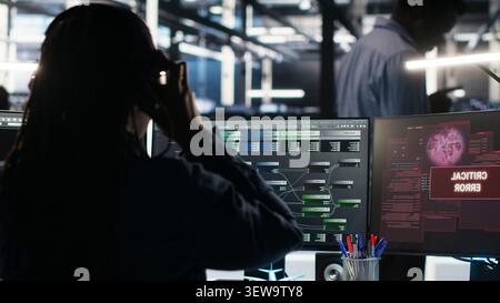 Data center engineer uses node tree software to identify equipment performance issues and data patterns. Stock Photo
