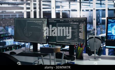 Server room PC screens track mainframe processing and machine learning datasets for AI operations. Stock Photo