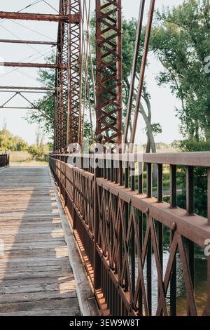 Golden hour light on an old rustic iron bridge Stock Photo