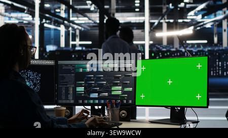 Data center technician uses node tree software to identify equipment performance issues and data patterns. Stock Photo