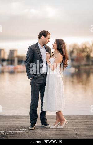 Romantic couple gazing at each other on a dock Stock Photo