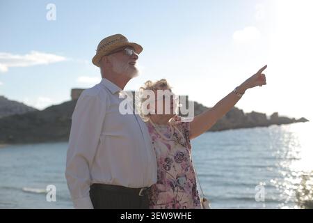 Senior couple enjoying a sunny day by the ocean Stock Photo