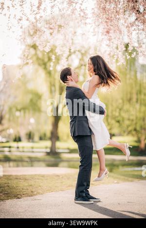 Happy couple celebrating love in spring park Stock Photo