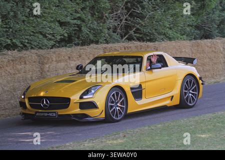 A stunning Mercedes-Benz SLS AMG Black Series in Solarbeam Yellow tackles the hillclimb course at the Goodwood Festival of Speed in 2013. Stock Photo