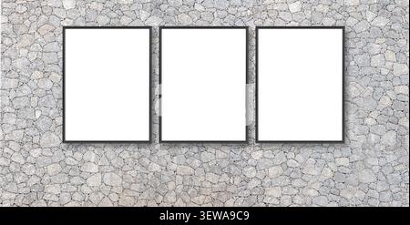 Three empty frames hanging on a textured grey stone wall, providing copy space Stock Photo