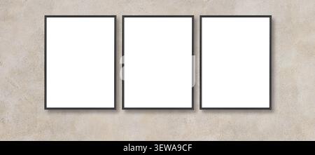 Three black empty frames hanging side by side on a textured concrete wall, offering copy space Stock Photo
