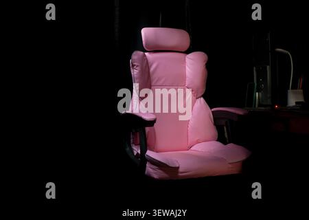 Stylish Home Office Setup with Pink Ergonomic Chair Stock Photo