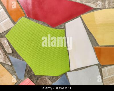 Vibrant Mosaic background Displaying Assemblage of Colored Tiles. Array of brightly colored and textured tiles arranged in captivating mosaic pattern. Stock Photo