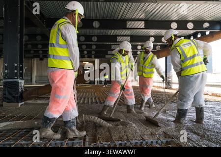 Keltbray workers pour concrete for the construction of BT’s new global headquarters at One Braham in Aldgate, London. Stock Photo