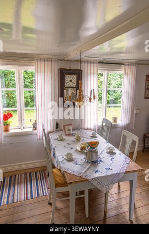 Interior of an old cottage with table settings for coffee Stock Photo