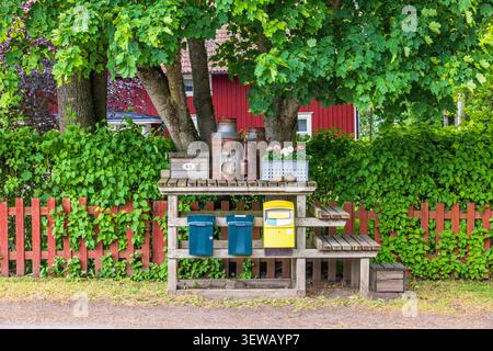 Old milk churn stand with post box and mailboxes in the countryside Stock Photo