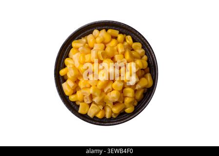 Golden, sweet canned corn kernels or maize for salads and vegetarian dishes. Canned corn as a food background for your design Stock Photo